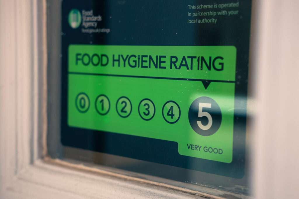food rating sign in a window of a convenience store