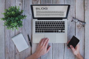 writing a blog, blogger influencer reading text on screen. Writing a blog for your business can help you attract your first customers